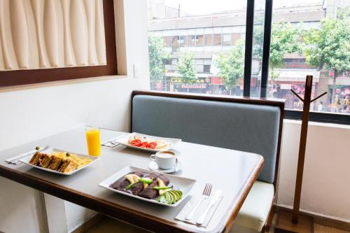a table with two plates of food on it at Hotel Castropol in Mexico City