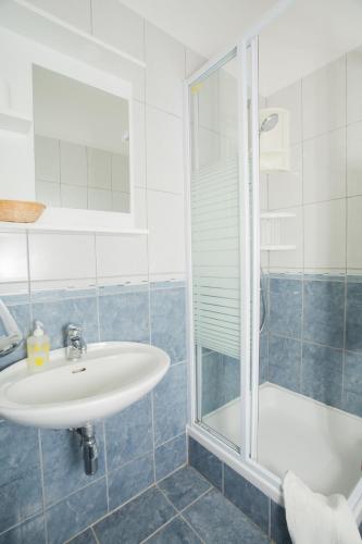 a bathroom with a sink and a shower at Hana Home - Apartments Tisno in Tisno