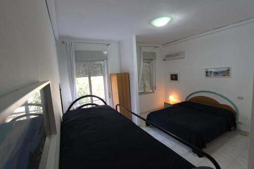 Кровать или кровати в номере Hotel Ristorante La Scogliera - NUOVA GESTIONE