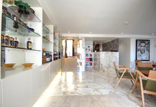 a living room with white walls and a marble floor at Solar Dos Mouros in Lisbon