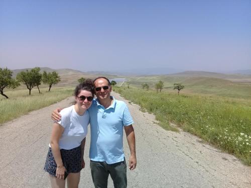 a man and a woman standing on a dirt road at My home udabno in Udabno