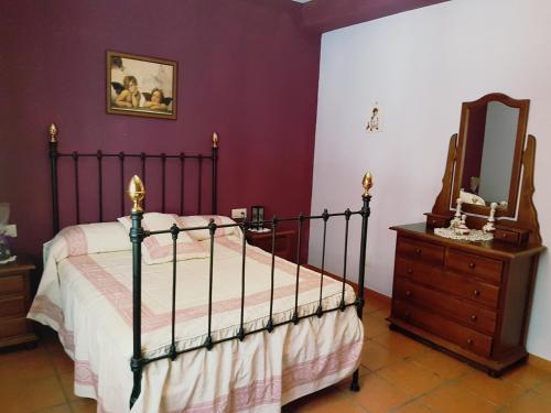 1 dormitorio con 1 cama y vestidor con espejo en CORTIJO LALO en Órgiva
