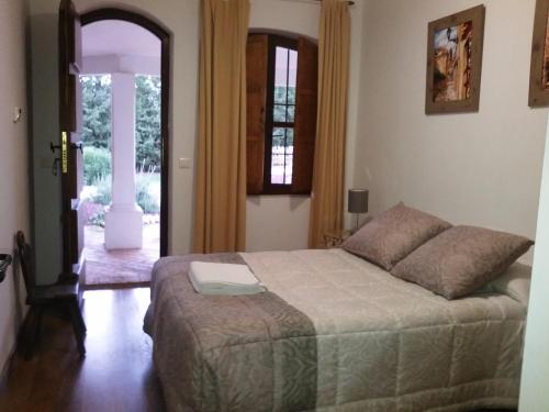 a bedroom with a bed and an open door at Chalet Alavesa - Lagunas de Ruidera in Argamasilla de Alba