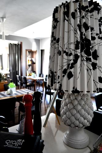 a room with a table with chairs and a vase at Hotel Graffit in Świebodzin