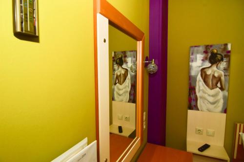 a mirror in a bathroom with a reflection of a woman at Iridanos in Antikyra