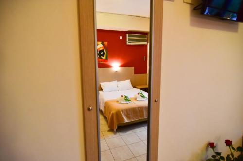 a view of a bedroom with a bed and a mirror at Iridanos in Antikyra