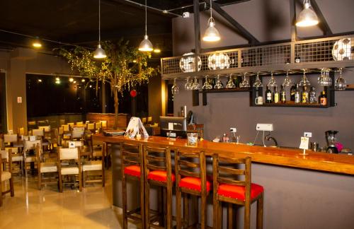 a restaurant with a bar with a lot of chairs at Hotel Med Barranquilla Centro in Barranquilla