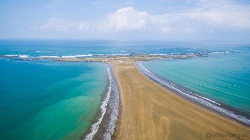 an aerial view of a beach near the ocean at Bungalows Ballena in Uvita