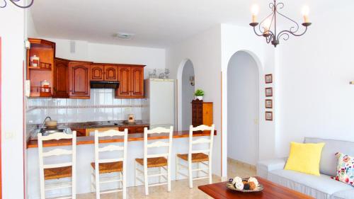 a living room with a kitchen with a couch and a table at Chocolate Rustic Apartment, in Tegueste in Tegueste