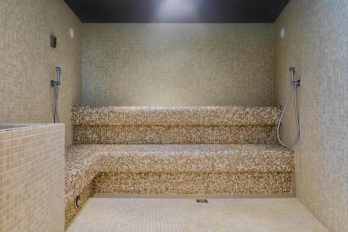 a bathroom with a shower with a large tub at Marina Palace Hotel 4 stelle S in Caorle
