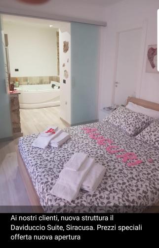 a bedroom with a bed with two towels on it at Il Daviduccio Suite in Siracusa