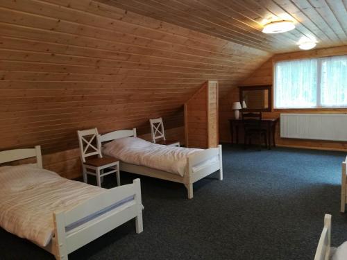 a room with two beds in a wooden cabin at Agroturystyka "U Sochy" in Ramleje