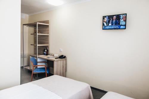 a hotel room with two beds and a desk at Nikotel Hotel Mykolaiv in Mykolaiv