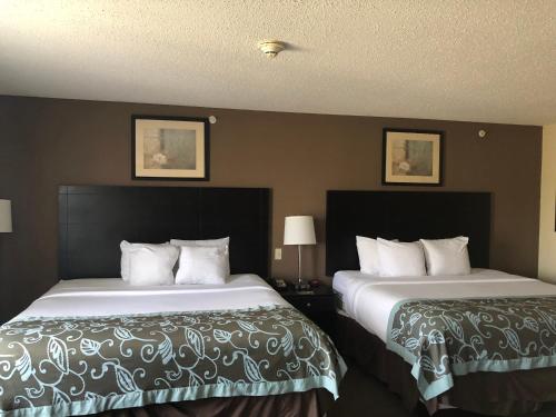 two beds in a hotel room next to each other at Wingate by Wyndham Erlanger - Florence - Cincinnati South in Erlanger