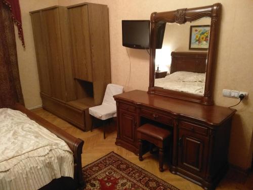 a bedroom with a dresser with a mirror and a bed at Sayat-Nova 2 in Gyumri