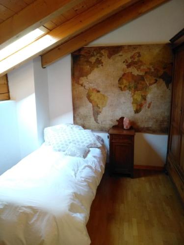 a bedroom with a bed and a map on the wall at SaMeCà in Tione di Trento