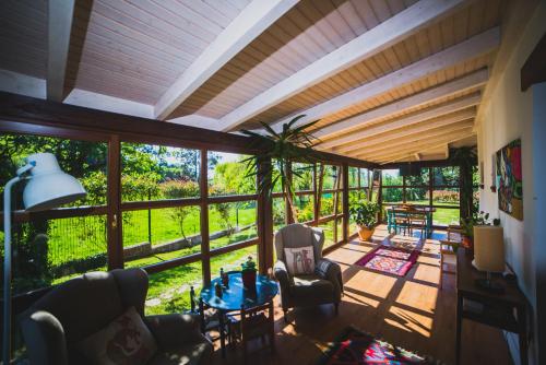 a living room filled with furniture and a large window at Casa Candelas in Lugo de Llanera