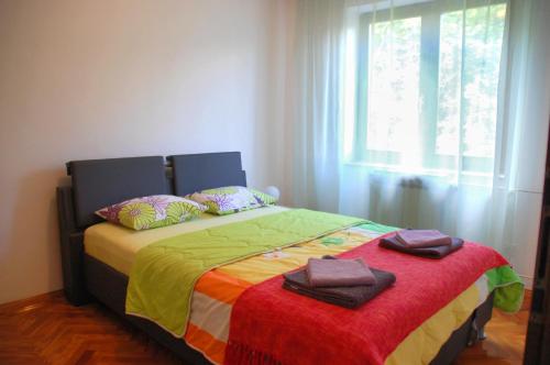a bedroom with a bed with towels on it at Spacious Apartment in quiet surrounding in Ičići