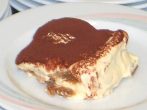 a piece of cake with chocolate sauce on a plate at Gasthof Obermair in Chienes