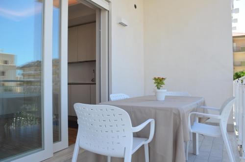 a white table and chairs on a balcony at apARTments Sperlonga in Sperlonga