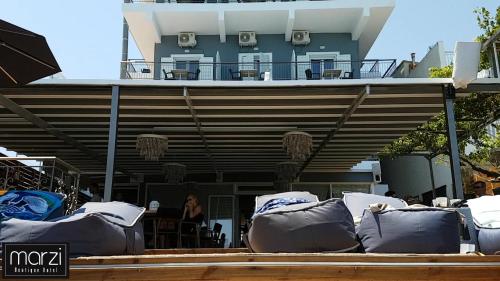 a building with a bunch of bean bags in front of it at Marzi Boutique Hotel in Nerátza