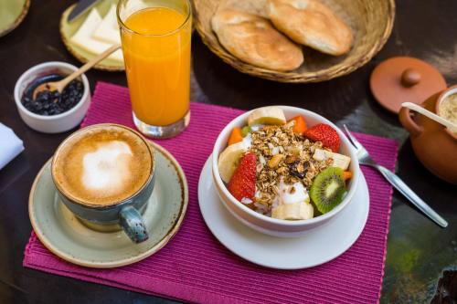 a table with a bowl of food and a cup of coffee at Pisac Inn in Pisac