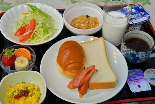 a tray of food with a plate of breakfast foods at Omura Central Hotel in Omura