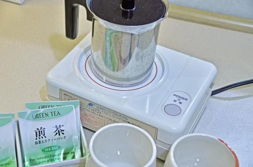 a food processor sitting on top of a box at Omura Central Hotel in Omura