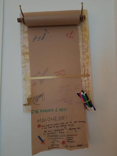 a white board with writing on it on a wall at HostelariaSP Boutique in Sao Paulo