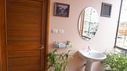 a bathroom with a sink and a mirror at T2B Home in Chiang Mai