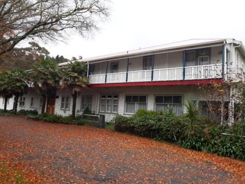 a building with a balcony on the side of it at Te Puia Hot Springs Hotel in Te Puia