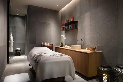 a bathroom with a bed and a sink at The Middle House in Shanghai
