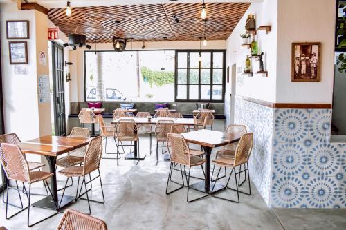 a restaurant with tables and chairs in a room at Cabañas del Capitan in Rincon de Guayabitos