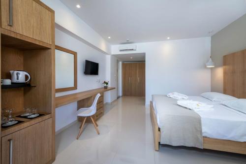 a hotel room with a bed and a desk at Gaia Palace in Mastichari
