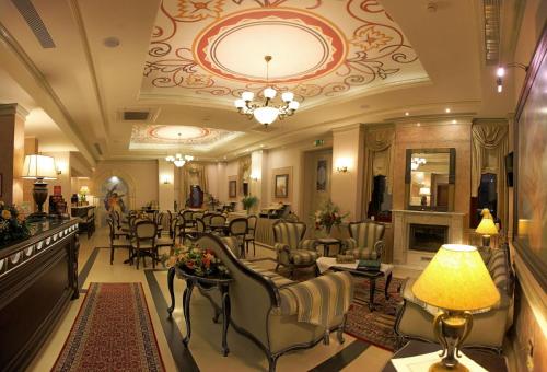 a lobby of a hotel with chairs and a fireplace at Theofilos Paradise Boutique Hotel in Mytilini