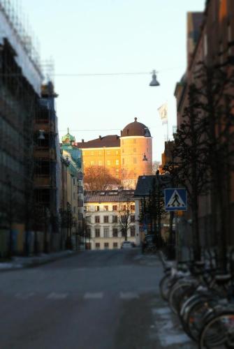 a city street with a building in the background with bikes parked at Hotell Centralstation in Uppsala