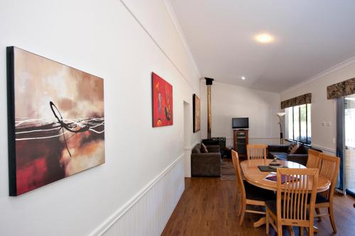 a dining room with a table and a living room at Margaret River Hideaway & Farmstay in Margaret River Town