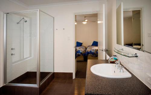 a bathroom with a sink and a shower at Margaret River Hideaway & Farmstay in Margaret River Town