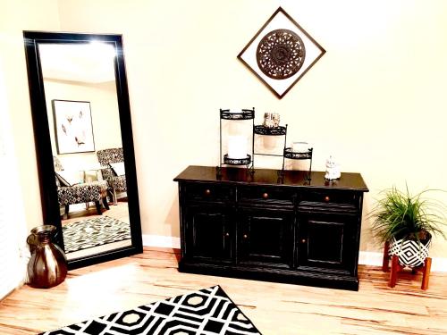 a black dresser in a room with a mirror at The Haven at Charity House in Waldorf