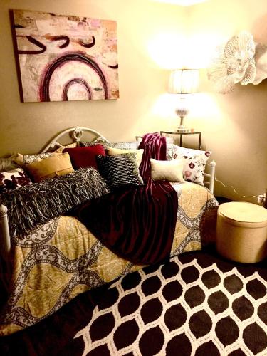 a bedroom with a bed with pillows on it at The Haven at Charity House in Waldorf