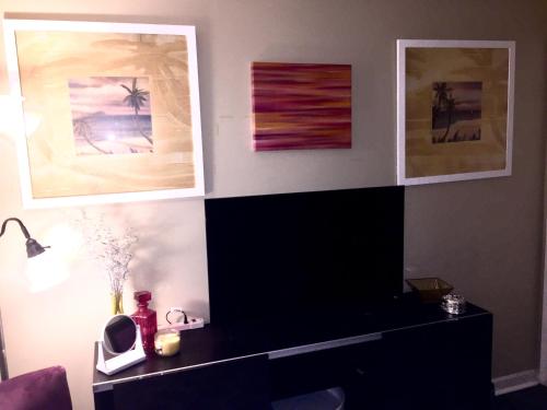 a living room with paintings on the wall at The Haven at Charity House in Waldorf