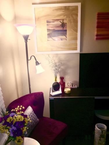 a living room with a red chair and a lamp at The Haven at Charity House in Waldorf