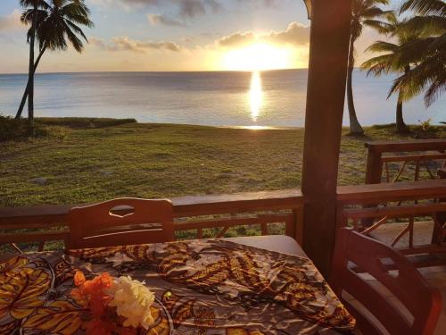 un letto su una veranda con vista sull'oceano di Tavake Villa ad Arutanga