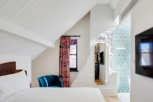 a bedroom with a bed and a tv in a room at Crystalbrook Albion in Sydney