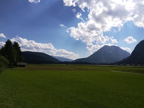 a green field with mountains in the background at Haus Bergesblick in Leutasch