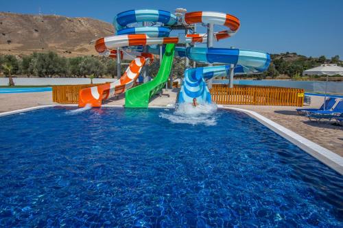 a water slide in a swimming pool at Olive Garden Hotel in Lardos