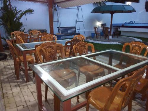 a table and chairs and an umbrella in a patio at Elliot Nature Resort in Galle