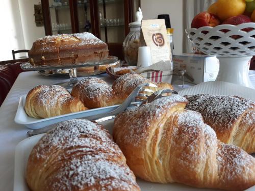 a bunch of croissants and other pastries on a table at Villa Orchidea Luxury B&B in Ispica