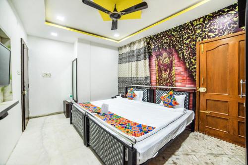 1 dormitorio con 1 cama y una pintura en la pared en FabHotel ABC View en Indore