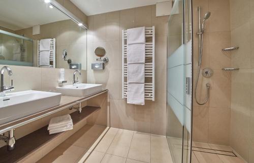 a bathroom with a sink and a shower at Rosentalerhof Hotel & Appartements in Saalbach Hinterglemm
